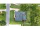 Overhead view of a house and surrounding property featuring a pool, lush lawn and bordering landscaping at 2908 Se 22Nd Ave, Ocala, FL 34471