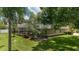 Lush backyard with screened pool, mature trees and manicured hedges at 2908 Se 22Nd Ave, Ocala, FL 34471