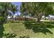 Expansive backyard with lush greenery, large trees, and a screened-in pool for outdoor enjoyment at 2908 Se 22Nd Ave, Ocala, FL 34471