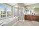 Elegant bathroom features a garden tub, separate shower, double vanity, and a large window for natural light at 2908 Se 22Nd Ave, Ocala, FL 34471