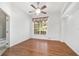 Bright bedroom with hardwood floors, large window, and ceiling fan at 2908 Se 22Nd Ave, Ocala, FL 34471