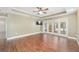 Bright main bedroom features hardwood floors, tray ceiling, a ceiling fan, and French doors to the lanai at 2908 Se 22Nd Ave, Ocala, FL 34471