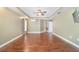 Spacious main bedroom features hardwood floors, tray ceiling, a ceiling fan, and an ensuite bathroom at 2908 Se 22Nd Ave, Ocala, FL 34471