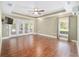 Large main bedroom features hardwood floors, tray ceiling, a ceiling fan, and French doors to the lanai at 2908 Se 22Nd Ave, Ocala, FL 34471