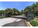A black iron gate with stone pillars and gold accents guards the entrance to the private community at 2908 Se 22Nd Ave, Ocala, FL 34471
