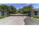 A black iron gate with stone pillars and gold accents guards the entrance to the private community at 2908 Se 22Nd Ave, Ocala, FL 34471