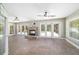 Open living room with a stone fireplace, tile flooring, and French doors that provide access to the outdoors at 2908 Se 22Nd Ave, Ocala, FL 34471