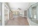 Spacious living room with stone fireplace, tile floors, ceiling fans and multiple French doors leading to the lanai at 2908 Se 22Nd Ave, Ocala, FL 34471