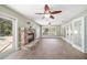 Bright living room features a stone fireplace, tile floors, ceiling fans and French doors leading to the pool at 2908 Se 22Nd Ave, Ocala, FL 34471