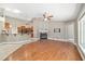 Spacious living room with a fireplace, hardwood floors, and an open layout to the kitchen at 2908 Se 22Nd Ave, Ocala, FL 34471