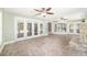 Open living area with stone fireplace, tile floor, and multiple glass doors at 2908 Se 22Nd Ave, Ocala, FL 34471