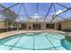 A luxurious screened-in pool with brick pavers and a tranquil atmosphere offers a relaxing outdoor space at 2908 Se 22Nd Ave, Ocala, FL 34471