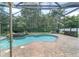 Screened in pool with brick patio and surrounding greenery at 2908 Se 22Nd Ave, Ocala, FL 34471
