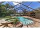 Beautiful pool and spa are surrounded by brick pavers inside the screened-in enclosure at 2908 Se 22Nd Ave, Ocala, FL 34471