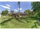 Beautiful screened-in pool area with lush green lawn, mature trees, and a relaxing outdoor space at 2908 Se 22Nd Ave, Ocala, FL 34471