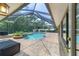 Screened in pool with brick patio and surrounding greenery at 2908 Se 22Nd Ave, Ocala, FL 34471