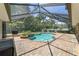 A beautiful screened-in pool with brick pavers and tropical plants, perfect for relaxing and entertaining at 2908 Se 22Nd Ave, Ocala, FL 34471