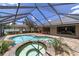 A backyard view of an inviting pool with attached hot tub and screened enclosure, perfect for entertaining at 2908 Se 22Nd Ave, Ocala, FL 34471
