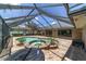 A luxurious pool with attached hot tub, brick pavers, and screened enclosure create a private outdoor retreat at 2908 Se 22Nd Ave, Ocala, FL 34471