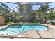 A screened-in pool with attached hot tub and brick pavers offers the perfect outdoor experience at 2908 Se 22Nd Ave, Ocala, FL 34471
