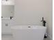 Modern bathroom with a contemporary soaking tub, black fixtures, and a bright white vanity at 3325 Sw 165Th Loop, Ocala, FL 34473