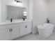 Bright bathroom features a double sink vanity and a modern soaking tub with black fixtures at 3325 Sw 165Th Loop, Ocala, FL 34473