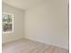 A bright bedroom features modern flooring and a window providing natural light and views of the outdoors at 3325 Sw 165Th Loop, Ocala, FL 34473