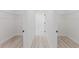 Bright hallway leading to other rooms in the house, modern flooring, and storage shelves at 3325 Sw 165Th Loop, Ocala, FL 34473