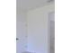 A hallway featuring a closed door on the left and opening to a bathroom on the right with tile floors at 3325 Sw 165Th Loop, Ocala, FL 34473