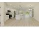 Modern kitchen with white cabinets, stainless steel appliances, and a spacious island open to living area at 3325 Sw 165Th Loop, Ocala, FL 34473