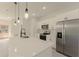 Stylish kitchen showcasing a quartz island, stainless steel appliances, and modern pendant lighting at 3325 Sw 165Th Loop, Ocala, FL 34473
