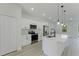 Modern kitchen features white cabinets, stainless steel appliances, and a spacious island with pendant lights at 3325 Sw 165Th Loop, Ocala, FL 34473