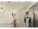 Bright, modern kitchen features stainless steel appliances, white cabinetry, and an island with a sink at 3325 Sw 165Th Loop, Ocala, FL 34473