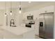 Modern kitchen with white cabinets, stainless steel appliances, and a large island with pendant lighting at 3325 Sw 165Th Loop, Ocala, FL 34473