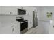 Modern kitchen features stainless steel appliances, white cabinets and countertops, with natural light at 3325 Sw 165Th Loop, Ocala, FL 34473