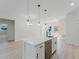 Open kitchen with an island, sink, modern light fixtures, and stainless steel appliances at 3325 Sw 165Th Loop, Ocala, FL 34473