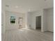 Bright and airy living room featuring light wood floors, a large window, and an open doorway at 3325 Sw 165Th Loop, Ocala, FL 34473