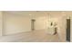 Open-concept living area features light wood floors and connects seamlessly to the modern kitchen at 3325 Sw 165Th Loop, Ocala, FL 34473