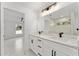 Modern bathroom featuring double vanity, marble countertops, and spacious walk-in shower at 36 Pine Radl, Ocala, FL 34472