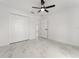 Minimalist bedroom with closet, ceiling fan, white walls, and marble-patterned flooring at 36 Pine Radl, Ocala, FL 34472