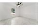 Bright bedroom featuring a ceiling fan, window, and elegant marble-patterned floors at 36 Pine Radl, Ocala, FL 34472