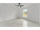 Bright bedroom with ceiling fan, window, and marble-patterned floors at 36 Pine Radl, Ocala, FL 34472