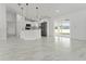 Bright, open kitchen with stainless steel appliances, marble tile flooring, and a large kitchen island at 36 Pine Radl, Ocala, FL 34472