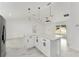 Open-concept kitchen featuring an island, stainless steel appliances, marble floors, and pendant lighting at 36 Pine Radl, Ocala, FL 34472