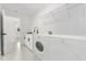 All-white laundry room features a washer and dryer at 36 Pine Radl, Ocala, FL 34472