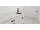 Beautiful laundry room boasts quartz countertops and black matte hardware at 36 Pine Radl, Ocala, FL 34472