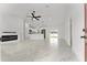 Open-concept living room with fireplace, bright white walls, and light-colored marble flooring at 36 Pine Radl, Ocala, FL 34472