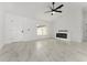 Bright living room with marble flooring, a fireplace, and large windows at 36 Pine Radl, Ocala, FL 34472