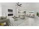 Comfortable living room with fireplace, marble floors, a ceiling fan, and open layout at 36 Pine Radl, Ocala, FL 34472