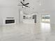 Bright living room with a modern fireplace, marble floors, and open kitchen area at 36 Pine Radl, Ocala, FL 34472